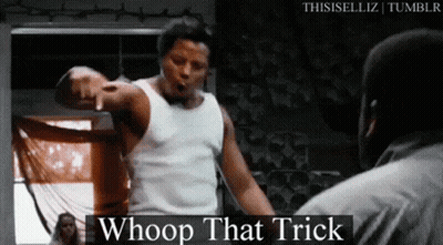 A Man In A White Tank Top Is Pointing At Another Man In A Black Shirt . GIF