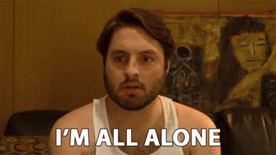 a man in a white tank top is saying i 'm all alone