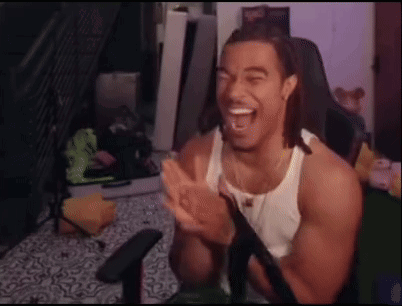 A Man In A White Tank Top Is Sitting In A Chair And Clapping His Hands . GIF