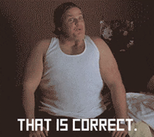 A Man In A White Tank Top Is Sitting On A Bed With The Words That Is Correct Above Him GIF