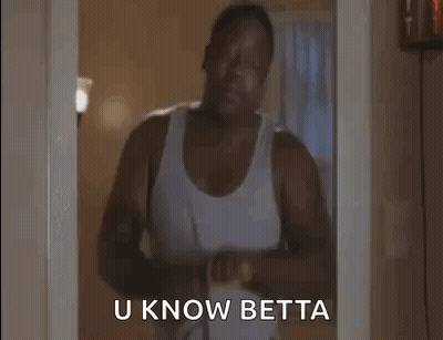 A Man In A White Tank Top Is Standing In A Doorway Holding A Belt And Says `` U Know Betta '' . GIF