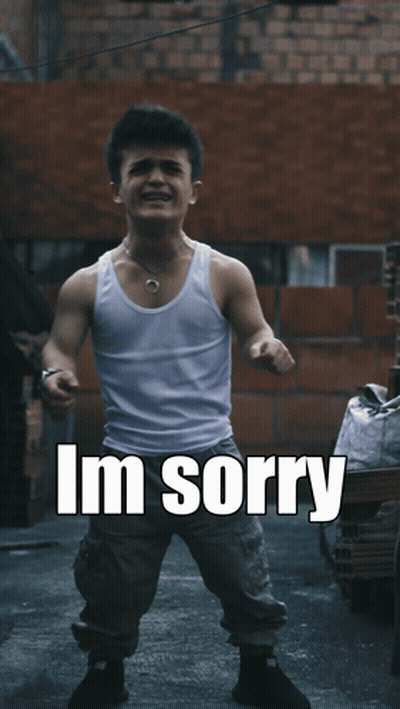A Man In A White Tank Top Is Standing In Front Of A Brick Wall With The Words " Dont Leave Me " Above Him GIF