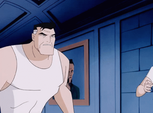 A Man In A White Tank Top Stands In Front Of A Mirror GIF
