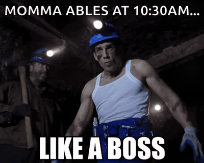 A Man In A White Tank Top Stands In Front Of A Sign That Says " Momma Ables At 10:30 Am ... Like A Boss " GIF