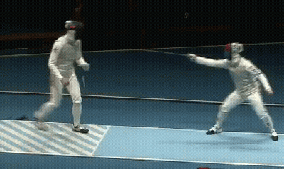 A Man In A White Uniform Is Holding A Sword In Front Of Another Man GIF