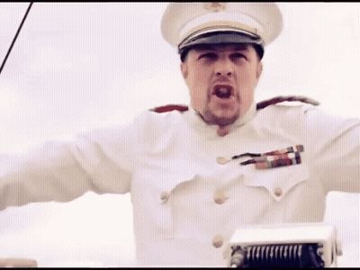 A Man In A White Uniform With A Hat And A Badge On His Chest GIF