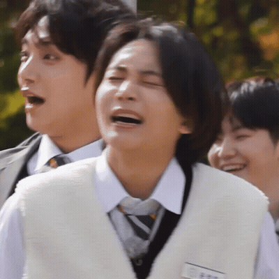 A Man In A White Vest And Tie Is Laughing GIF