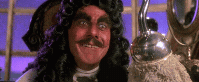 A Man In A Wig And Mustache Is Smiling And Holding A Hook . GIF