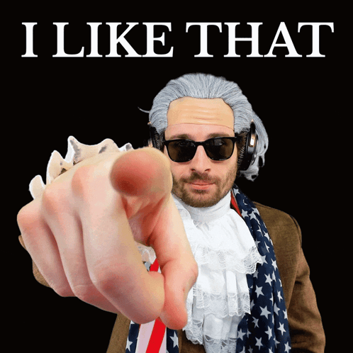 A Man In A Wig And Sunglasses Is Pointing At The Camera With The Words I Like That Behind Him GIF