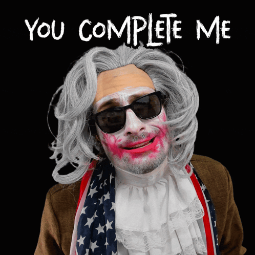 A Man In A Wig And Sunglasses Says " You Complete Me " On A Black Background GIF