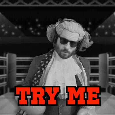 A Man In A Wig And Sunglasses Stands In A Boxing Ring With The Words Try Me Behind Him GIF