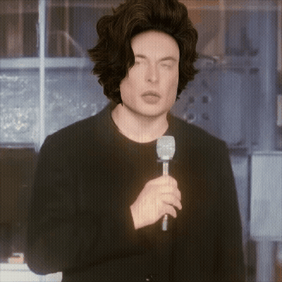 A Man In A Wig Is Holding A Microphone GIF