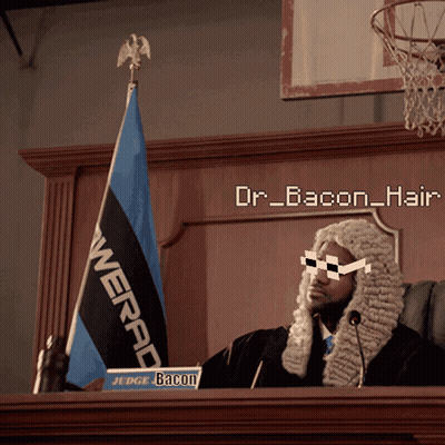 A Man In A Wig Is Sitting At A Podium With A Sign That Says " Judge Bacon " GIF