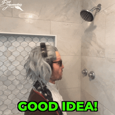 A Man In A Wig Is Taking A Shower With The Words Good Idea Written In Green GIF