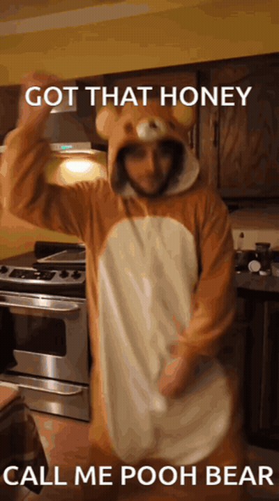 A Man In A Winnie The Pooh Bear Costume Is Dancing GIF