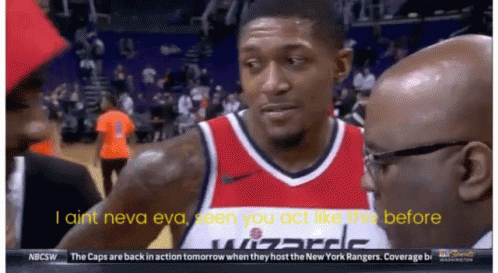 A Man In A Wizards Jersey Talks To A Man In A Suit GIF