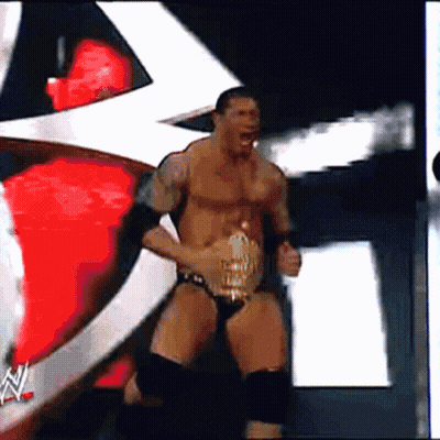 a man in a wrestling outfit is holding a wrestling belt