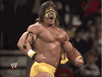 A Man In A Wrestling Outfit With The Letter W On The Bottom Right GIF