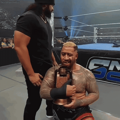 A Man In A Wrestling Ring Holds A Lantern In Front Of A Gm Logo GIF