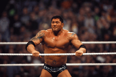 A Man In A Wrestling Ring Holds A Rope In His Hands GIF