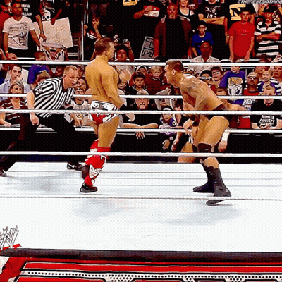 A Man In A Wrestling Ring Holds A Sign That Says " I Am A Fighter " GIF