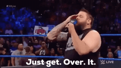 A Man In A Wrestling Ring Is Drinking From A Blue Cup . GIF