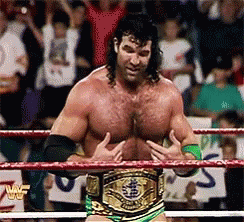 A Man In A Wrestling Ring With A Belt That Says Wwe On It GIF