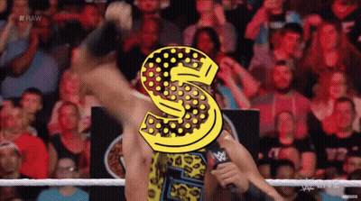 A Man In A Wrestling Ring With A Letter S On His Head GIF