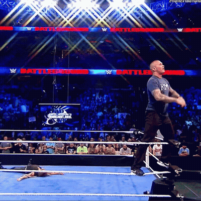 A Man In A Wrestling Ring With A Sign That Says Battleground In The Background GIF