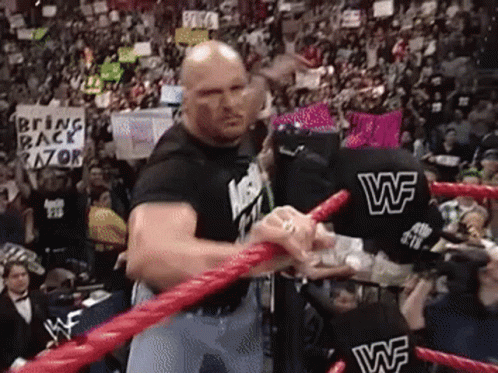 A Man In A Wrestling Ring With A Sign That Says Bring Back Razor . GIF