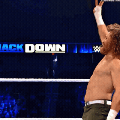 A Man In A Wrestling Ring With A Sign That Says ' Ck Down ' GIF