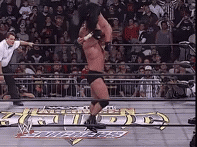 A Man In A Wrestling Ring With A Sign That Says ' Wrestling ' GIF