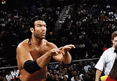 A Man In A Wrestling Ring With A W Logo On His Arm GIF