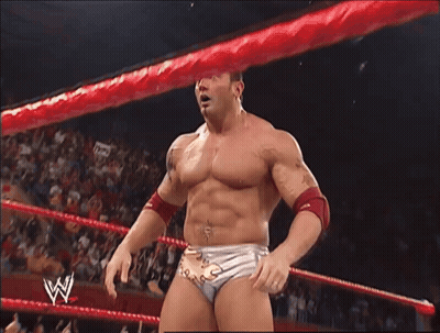 A Man In A Wrestling Ring With A W Logo On His Belt GIF
