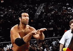 A Man In A Wrestling Ring With A W Logo On His Shirt GIF