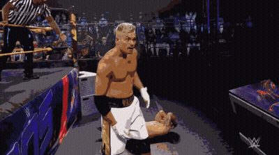 A Man In A Wrestling Ring With A W Logo On The Corner GIF