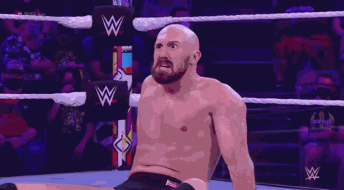 A Man In A Wrestling Ring With A W Logo On The Ropes GIF