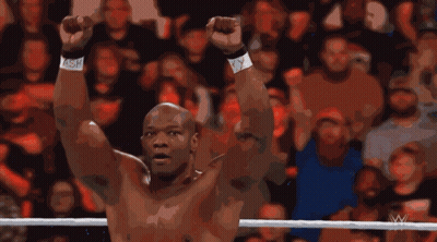 A Man In A Wrestling Ring With His Arms In The Air GIF