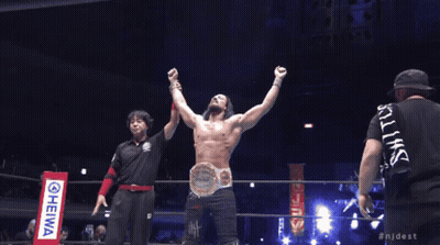 A Man In A Wrestling Ring With His Arms In The Air And The Hashtag Njdest On The Bottom GIF