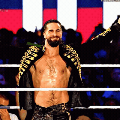 A Man In A Wrestling Ring With His Arms Outstretched And The Word Slam On The Bottom Right GIF