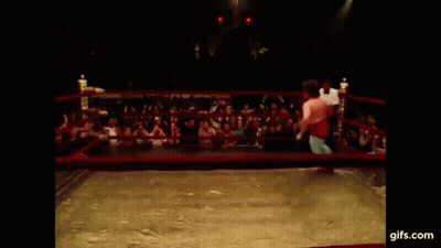 A Man In A Wrestling Ring With His Arms Outstretched . GIF