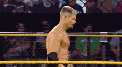 A Man In A Wrestling Ring With The Hashtag # 205Live At The Top GIF