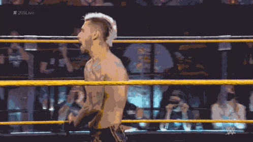 A Man In A Wrestling Ring With The Hashtag # 205Live On The Bottom GIF