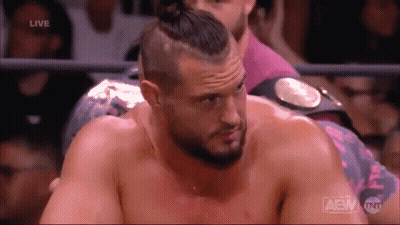 A Man In A Wrestling Ring With The Word Aew On The Bottom Right GIF
