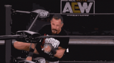 A Man In A Wrestling Ring With The Word All Elite Wrestling Behind Him GIF