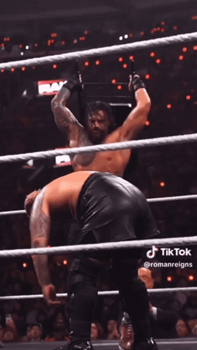 A Man In A Wrestling Ring With The Word Raw On The Wall Behind Him GIF