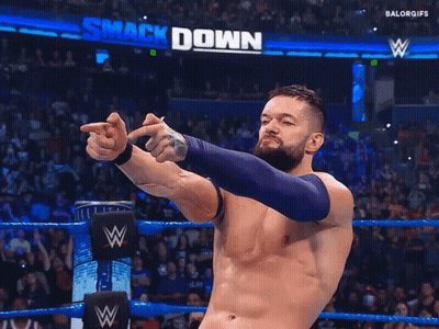 A Man In A Wrestling Ring With The Word Smack Down On The Wall Behind Him GIF