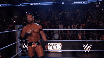 A Man In A Wrestling Ring With The Word Yeah On His Chest GIF