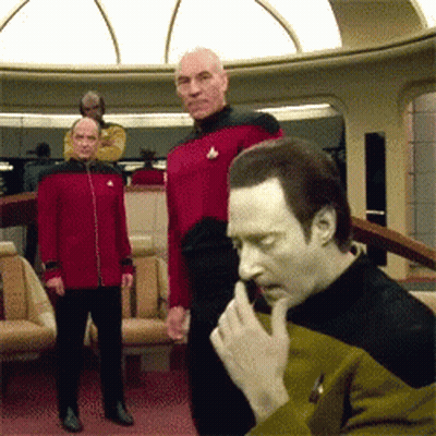 A Man In A Yellow And Black Uniform Has A Star Trek Logo On His Shirt GIF