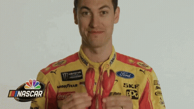A Man In A Yellow And Red Ford Shirt Is Holding A Lobster GIF